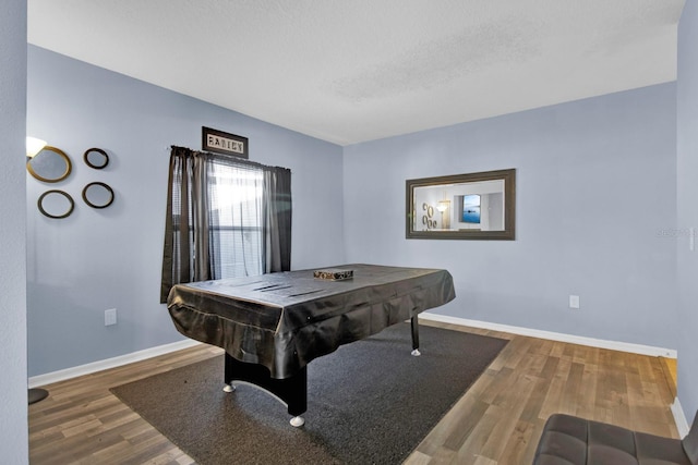 rec room with pool table, a textured ceiling, and hardwood / wood-style flooring