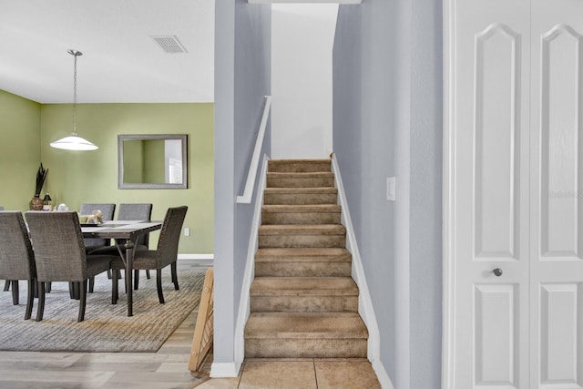 stairway with hardwood / wood-style flooring