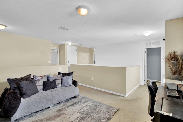 carpeted living room featuring a textured ceiling