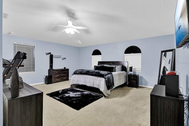 bedroom with ceiling fan and light carpet