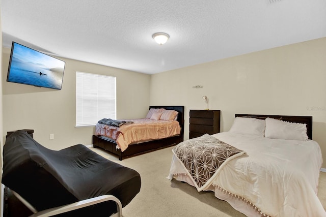 bedroom featuring carpet flooring and a textured ceiling