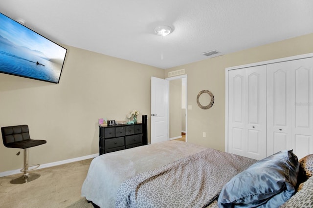 carpeted bedroom featuring a closet