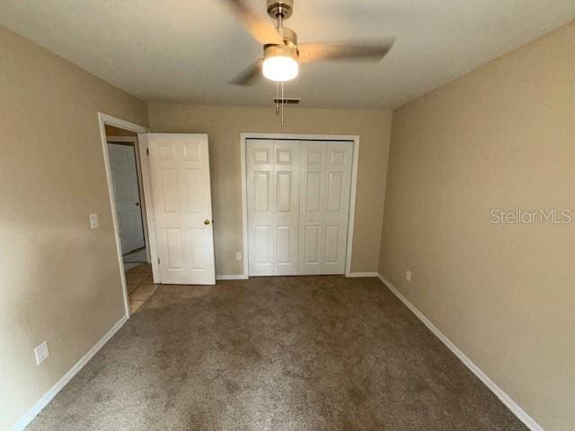 unfurnished bedroom featuring ceiling fan, carpet floors, and a closet