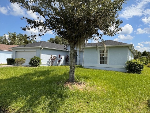 ranch-style home featuring a front lawn and a garage