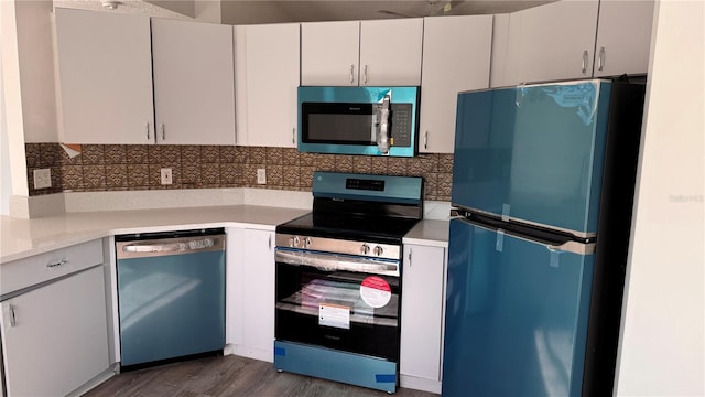 kitchen featuring decorative backsplash, dark hardwood / wood-style flooring, stainless steel appliances, and white cabinetry