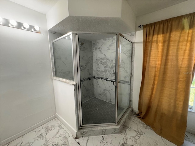 bathroom featuring a shower with door