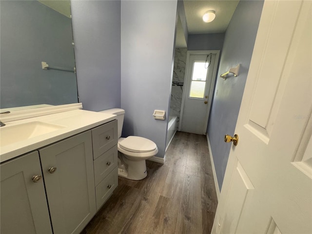 bathroom featuring vanity, hardwood / wood-style flooring, and toilet