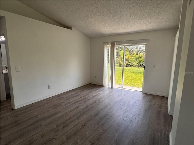 unfurnished room featuring vaulted ceiling, dark hardwood / wood-style flooring, and a textured ceiling