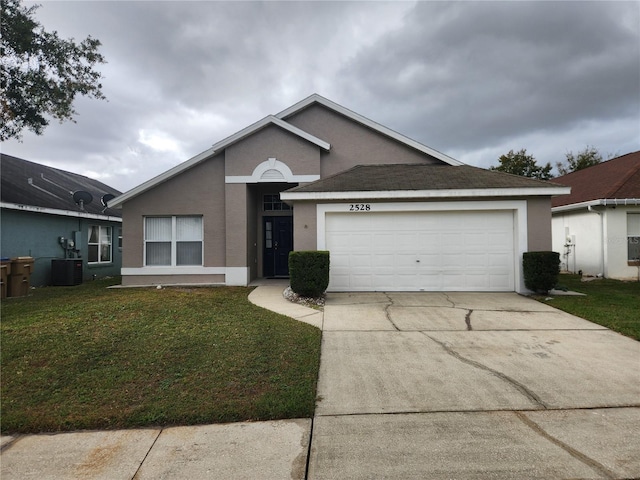 ranch-style home featuring a garage, a front yard, and central AC