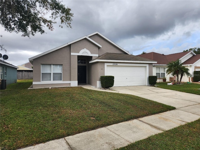 single story home featuring a garage and a front yard