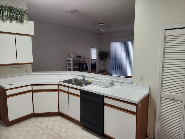 kitchen featuring dishwasher, kitchen peninsula, white cabinetry, and sink