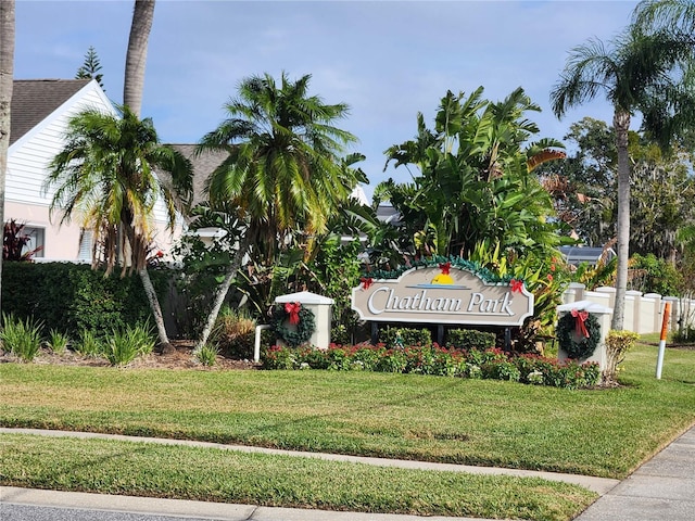 community sign featuring a lawn