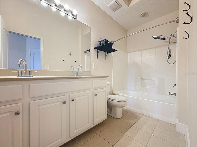 full bathroom featuring vanity, tile patterned floors, shower / washtub combination, toilet, and a textured ceiling