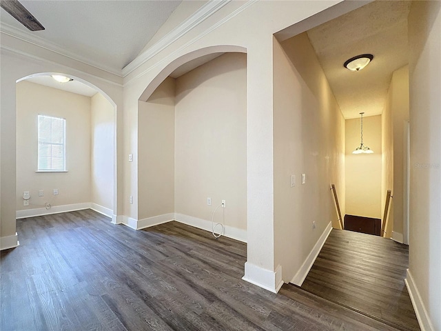 corridor featuring dark hardwood / wood-style floors and crown molding