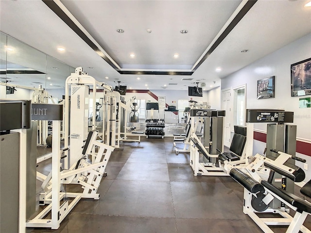 exercise room with a tray ceiling