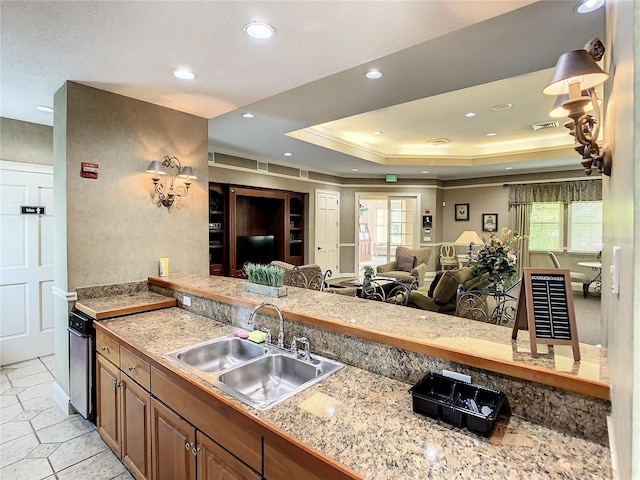 kitchen with a tray ceiling and sink