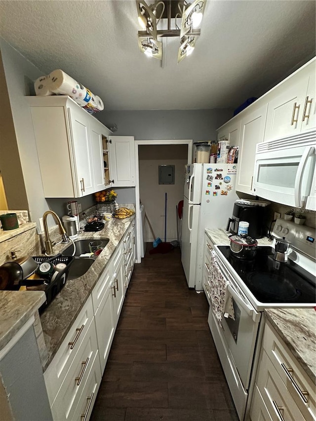 kitchen featuring white appliances, dark wood-type flooring, white cabinetry, light stone counters, and a textured ceiling