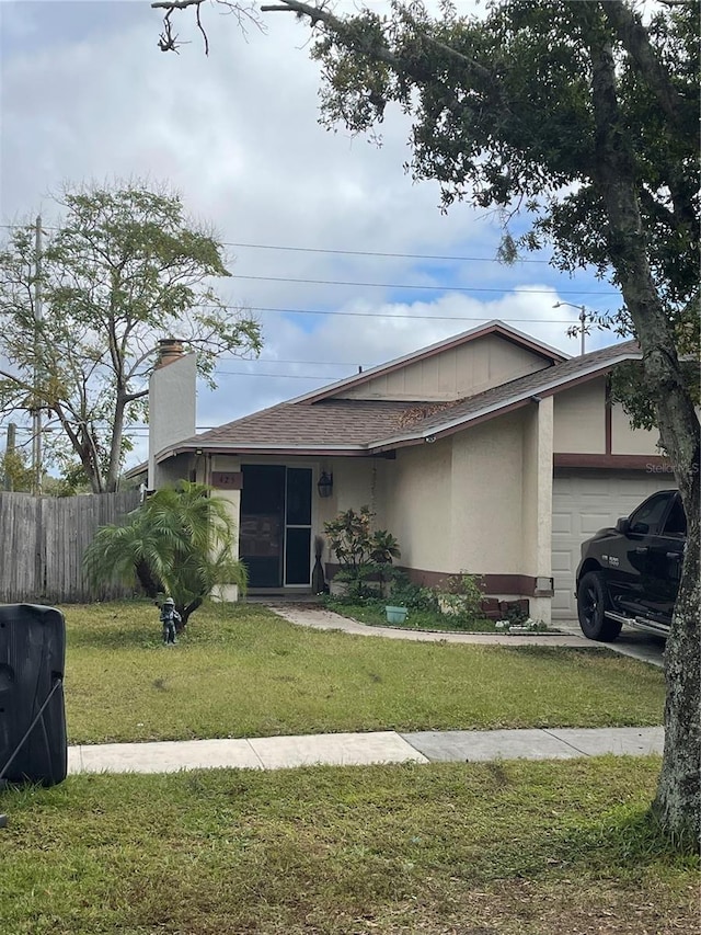 ranch-style house with a garage and a front yard