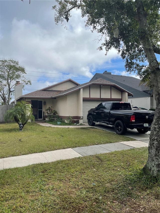 view of front facade featuring a garage and a front yard