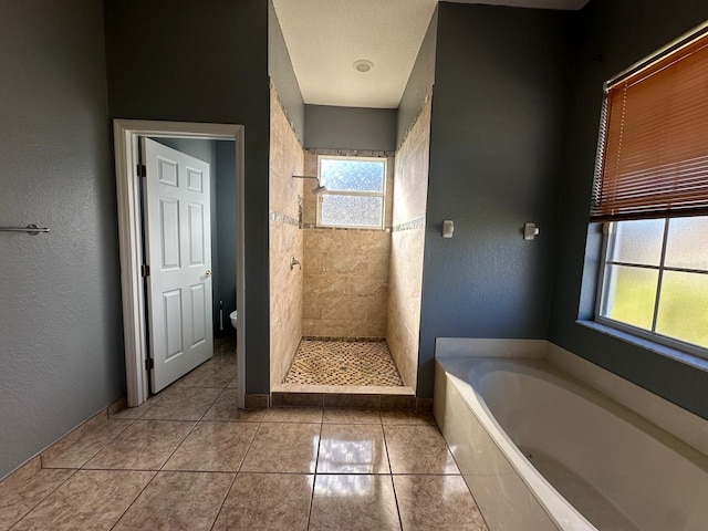 bathroom with tile patterned flooring, toilet, and independent shower and bath