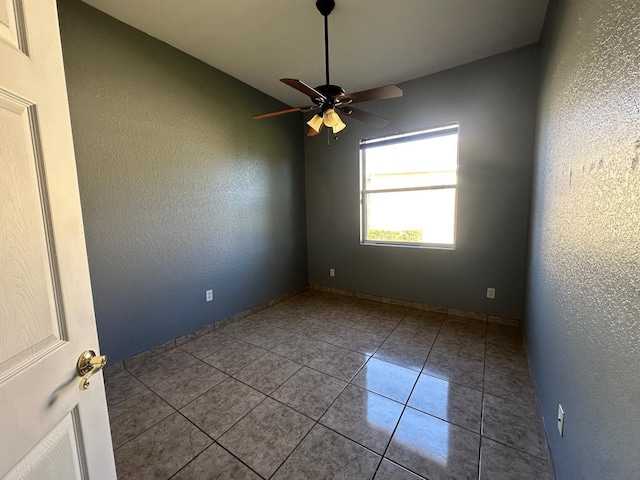 unfurnished room with tile patterned floors and ceiling fan