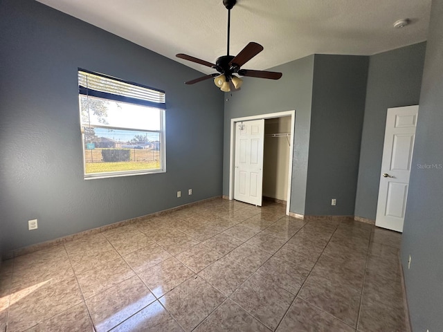 unfurnished bedroom with ceiling fan, a closet, and tile patterned flooring