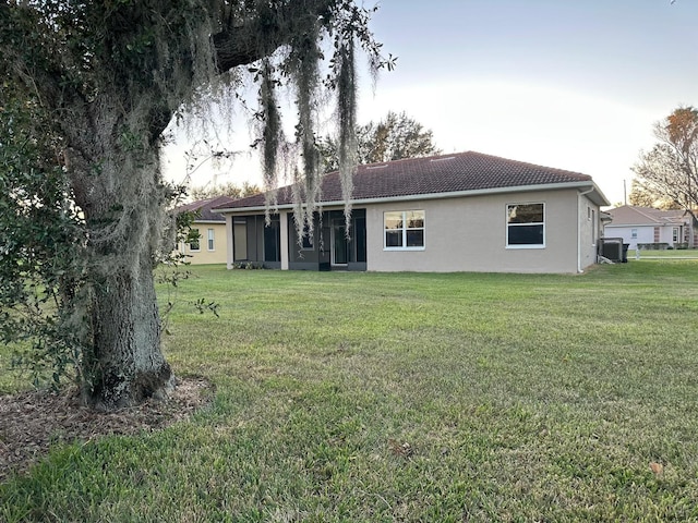 back of house with a lawn