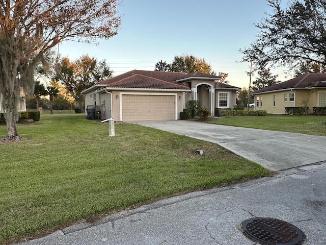 view of front of home with a yard and a garage