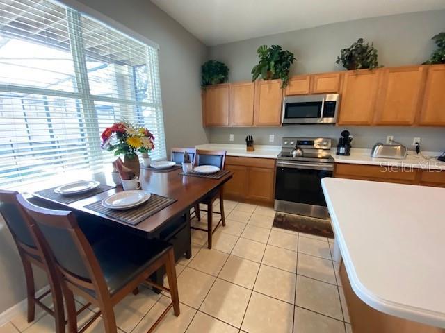 kitchen featuring appliances with stainless steel finishes and light tile patterned floors