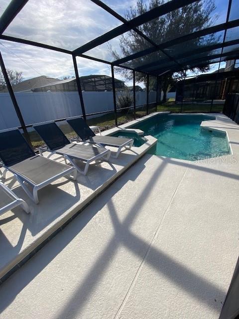 view of pool with a lanai and a patio