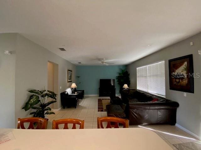 tiled dining room with ceiling fan