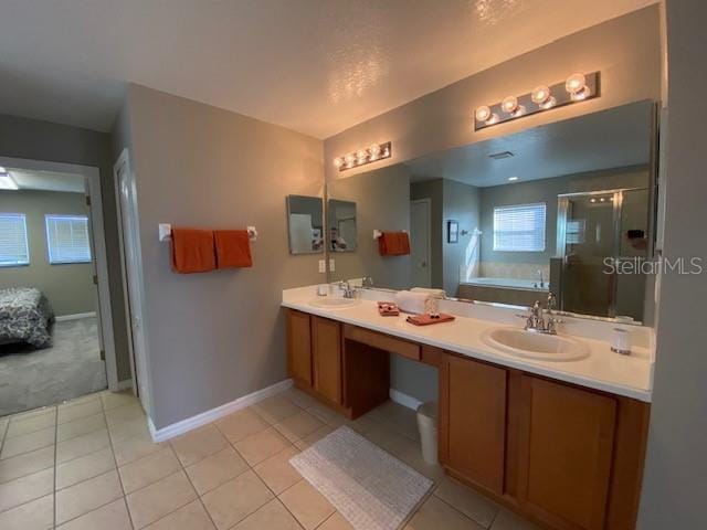 bathroom with tile patterned floors, vanity, and independent shower and bath