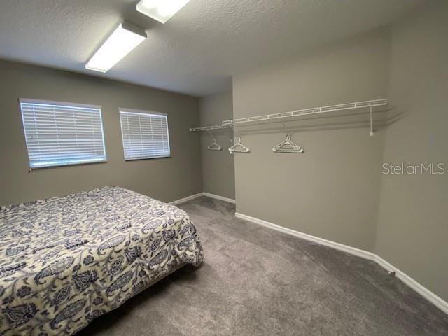 carpeted bedroom featuring a textured ceiling