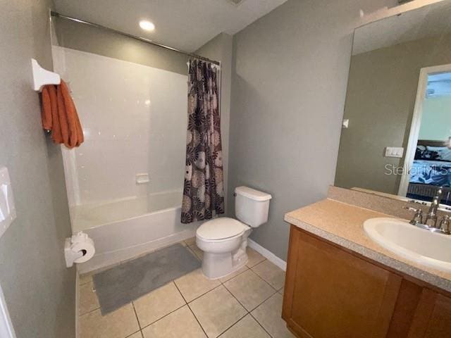 full bathroom featuring toilet, vanity, tile patterned floors, and shower / bathtub combination with curtain