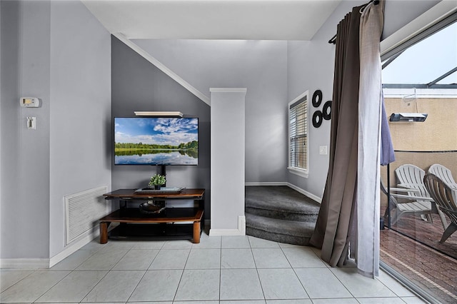 interior space featuring plenty of natural light, light tile patterned floors, and ornamental molding