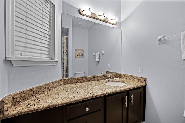 bathroom with vanity and toilet