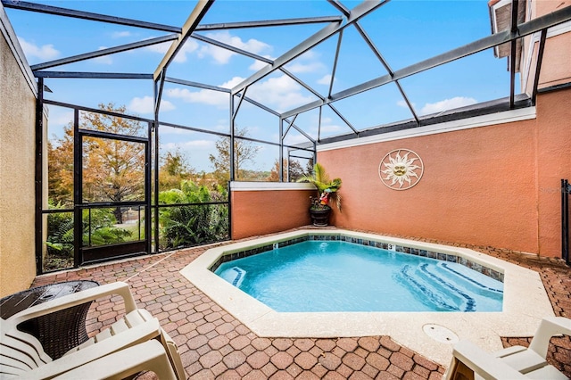 view of pool with a patio area and a lanai