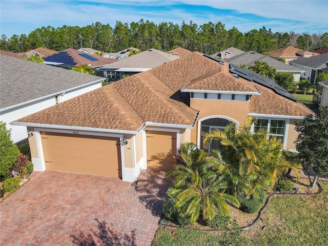 view of front of home featuring solar panels and a garage