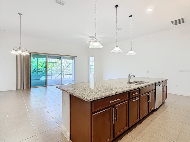 kitchen with sink, an island with sink, stainless steel dishwasher, and light tile patterned floors