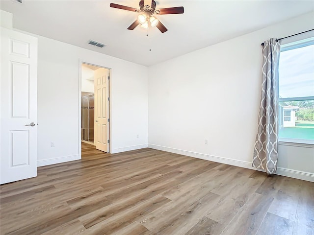 empty room featuring hardwood / wood-style floors and ceiling fan