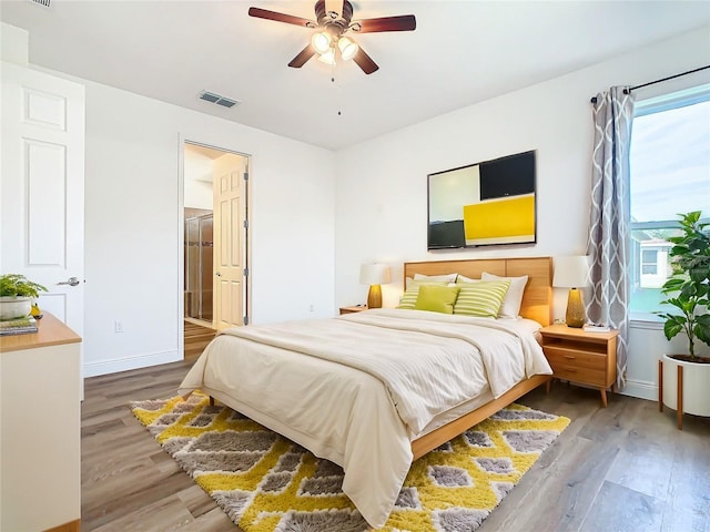 bedroom with ceiling fan and hardwood / wood-style flooring