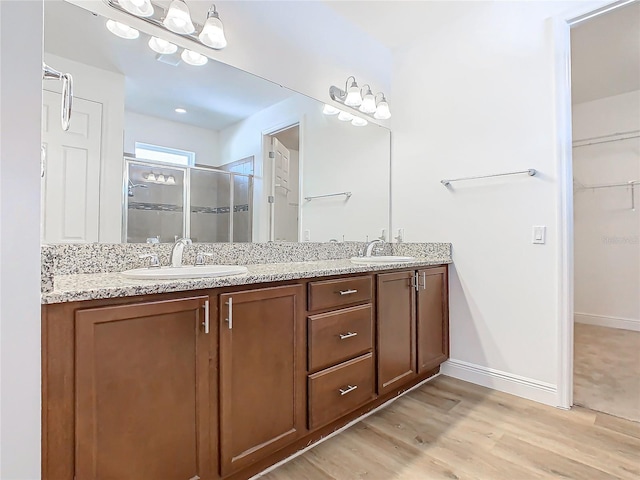 bathroom with vanity, hardwood / wood-style flooring, and walk in shower