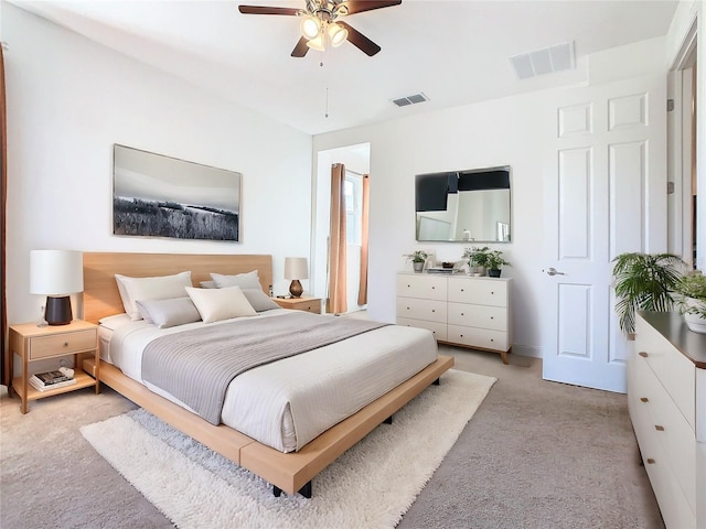 bedroom featuring light colored carpet and ceiling fan