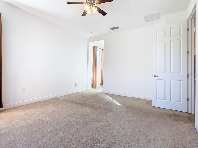 unfurnished room with light colored carpet and ceiling fan