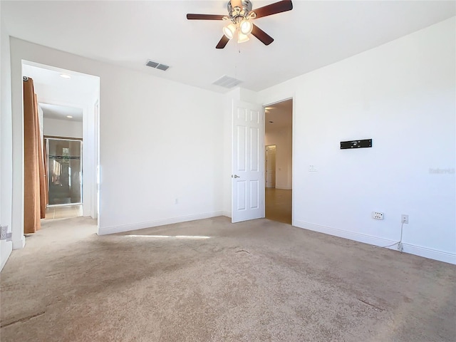 empty room featuring light colored carpet and ceiling fan