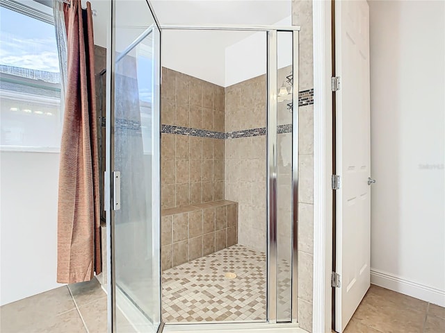 bathroom featuring tile patterned flooring and a shower with shower door