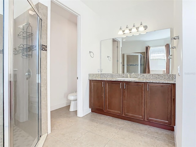 bathroom with tile patterned flooring, toilet, vanity, and walk in shower