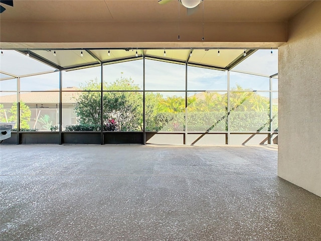 unfurnished sunroom featuring ceiling fan