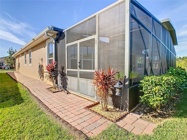 rear view of property with glass enclosure