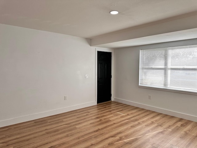 empty room with light hardwood / wood-style floors